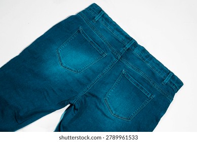 Close up view of back pockets on blue jeans with stitching material clothing trousers construction background wardrobe denimwear fashionable