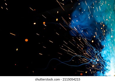 Close up view and background of the gas metal arc welding (GMAW) process with sparks, light, bokeh effect and smoke. - Powered by Shutterstock