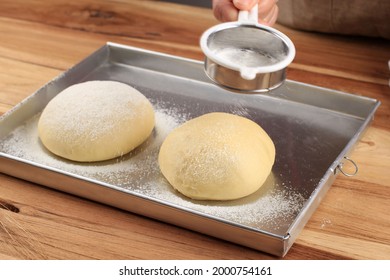 Close up view of baker kneading dough. Homemade bread. Hands preparing bread dough on wooden table. Preparing traditional homemade bread. Woman hands kneading fresh dough for making bread