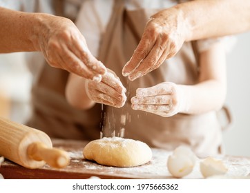 Close up view of bakers are working. Homemade bread. Hands preparing dough on wooden table.  - Powered by Shutterstock