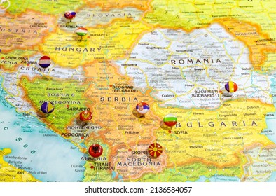 Close up view of Balkan peninsula on geographical globe, Map shows capitals countries Serbia  Belgrade, Bulgaria  Sofia, Romania  Bucharest, Montenegro  Podgorica, Albania  Tirana and their flags