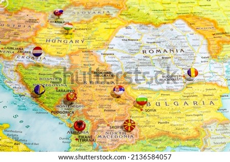 Close up view of Balkan peninsula on geographical globe, Map shows capitals countries Serbia  Belgrade, Bulgaria  Sofia, Romania  Bucharest, Montenegro  Podgorica, Albania  Tirana and their flags