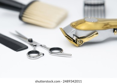 close up view of barber tools on a white table, hairdresser equipment on a white background - Powered by Shutterstock