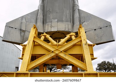 A Close Up View of the Base of a Rocket Sitting on a Launch Stand