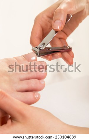 Close up View Of A Beautician's Hand Cutting Client's Toenails