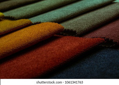 Close up view of a beautiful abstract art background of detail bright colorful fabric palette texture samples.