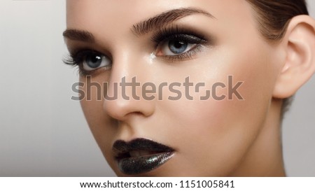 Close up view of beautiful blue female eyes. Perfect trendy eyebrow and with extreme long eyelashes. Good vision, contact lenses, brow bar or fashion eyebrow makeup concept