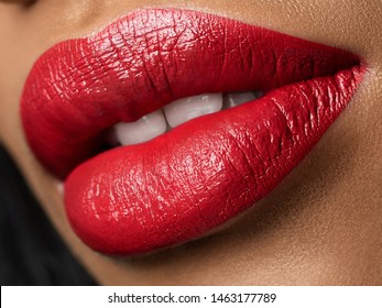 Close up view of beautiful woman lips with red lipstick. Fashion make up. Cosmetology, drugstore or fashion makeup concept. Studio shot