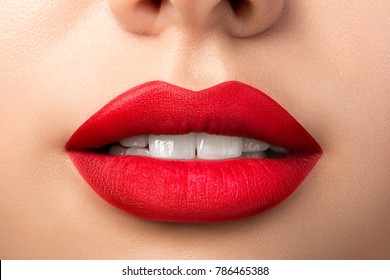 Close Up View Of Beautiful Woman Lips With Red Matt Lipstick. Open Mouth With White Teeth. Cosmetology, Drugstore Or Fashion Makeup Concept. Beauty Studio Shot. Passionate Kiss