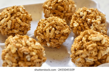 Close up view of Bengali Traditional Puffed Rice Balls is a sweet made using puffed rice mixed with jaggery, other named Murmura Laddoo, Churmura Laddoo or Pori Urundai, flattened rice sweet ball. - Powered by Shutterstock