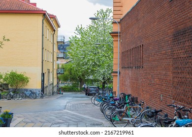 Close up view of bicycle parking on small street in downtown,  Uppsala, Sweden. Healthy lifestyle concept. Sweden. Uppsala. 05.14.2022.