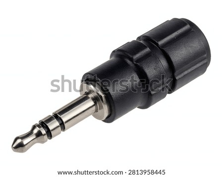 A close up view of a black audio jack adapter for connecting various electronic devices and sound equipment