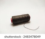 close up view of black thread.spool of sewing thread isolated on white background

