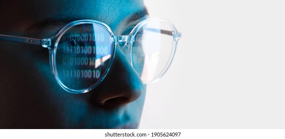 Close up view of blue eye in glasses with futuristic holographic interface to display data. Portrait of beautiful young woman, half of face. Augmented reality, future technology, internet concept.