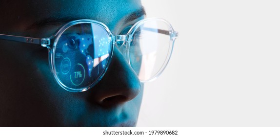 Close up view of blue eye in glasses with futuristic holographic interface to display data. Portrait of beautiful young woman, half of face. Augmented reality, future technology, internet concept. - Powered by Shutterstock