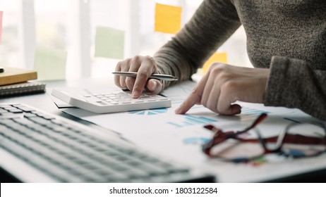 Close up view of bookkeeper or financial inspector hands making report, calculating or checking balance. Home finances, investment, economy, saving money or insurance concept - Shutterstock ID 1803122584