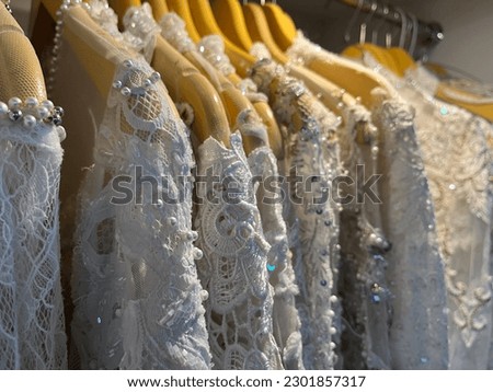 Close up view of bridal dresses collection with luxury design being displayed at showroom. Stock foto © 