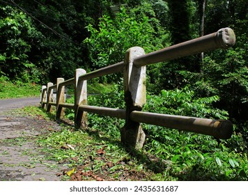 Close up view of bridge railing in mountain forest.