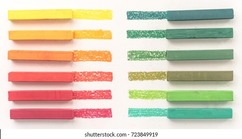 Close up view of bright colorful pastel chalks and their pigments on white background - Powered by Shutterstock