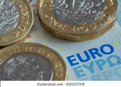 A close up view of British Pound coins on Euro banknote
