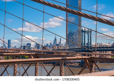 Close Up View Of The Brooklyn Bridge With Empire State Building In The Background.