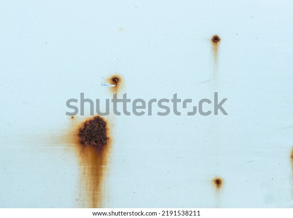 Close\
up view of brown rust spots on white car paint\
job
