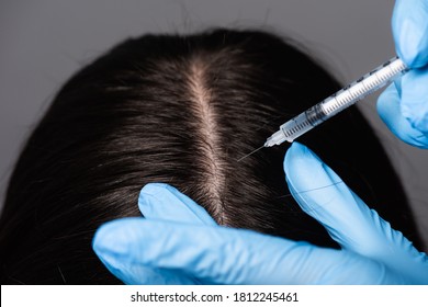 Close Up View Of Brunette Woman Having Scalp Mesotherapy Isolated On Black