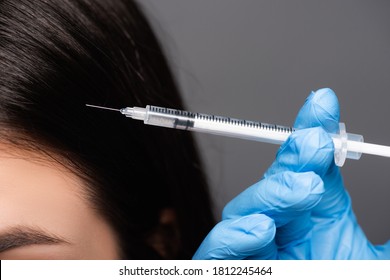 Close Up View Of Brunette Woman Having Scalp Mesotherapy Isolated On Black