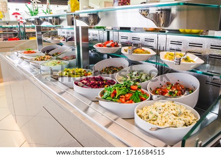 close up view of buffet table with different salads  in big white plates. hotel dinning room . all inclusive concept .