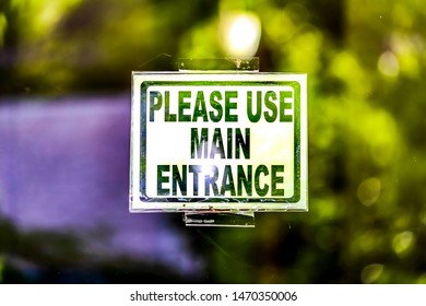 Close Up View Of A Building Sign That Reads Please Use Main Entrance