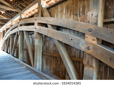 Close Up View Of The Burr Arch Truss Of A Restored Old 1844 Covered Bridge On A Sunny Day