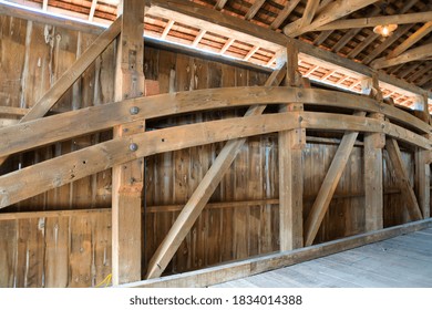 Close Up View Of The Burr Arch Truss Of A Restored Old 1844 Covered Bridge On A Sunny Day 