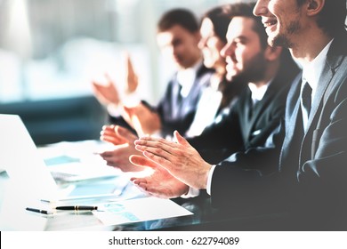 Close up view of business seminar listeners clapping hands. Professional education, work meeting, presentation or coaching concept.Horizontal,blurred background