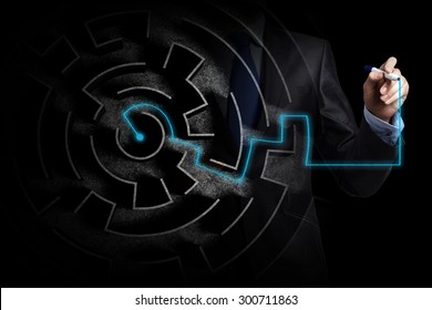 Close up view of businessman drawing way in labyrinth - Shutterstock ID 300711863