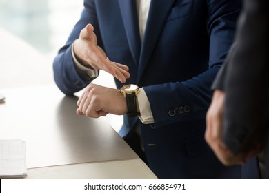 Close Up View Of Businessman Wearing Suit Pointing On Hand Expensive Luxury Wristwatch At Meeting, Showing Unpunctual Partner He Is Being Late, Punctuality Management Concept, Time Is Money 