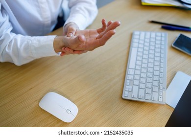 Close Up View Of Businesswoman Holding Hand Feeling Wrist Pain From Using Computer Mouse And Keyboard Long Time