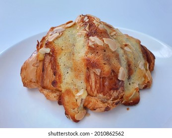 A Close View Buttery, Flaky, Croissant On White Plate And Isolated In White Background.