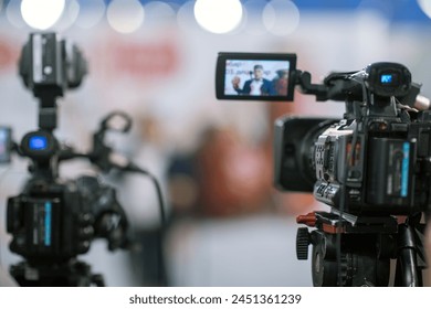 Close up view of a camera capturing a press conference