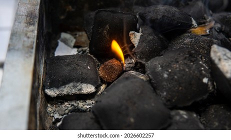 Close Up View Of Camping Charcoal Cock Fire Starter Burning Between The Charcoal Briquettes For Barbeque Party.