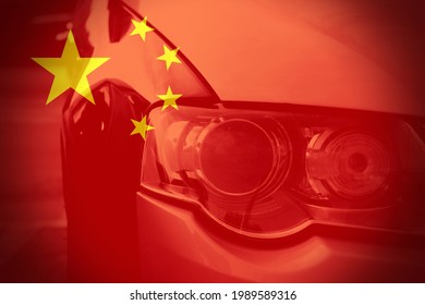 Close Up View Of A Car Headlight With The Chinese Flag As Background. Concept Of Cars In China Or Chinese Car Industry. 