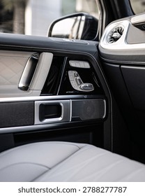 Close up view of a car interior featuring dashboard controls switches and chrome trim detail
