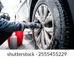 Close up view of car rim cleaning with shampoo and brush. Professional car wash.