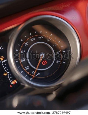 Close up view of a car speedometer and dashboard gauge showing speed and RPM.
