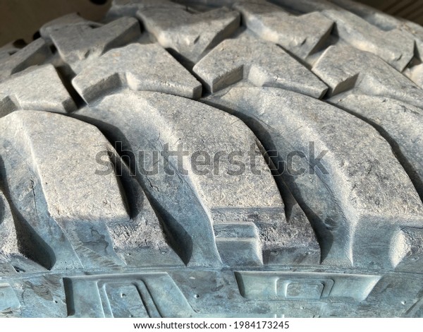 Close up view of car Tyre tread on a sunny day.\
Dirty Tyre tread on a close up view. Can be used for background or\
texture.