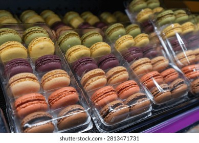 Close view of cases of multicolored macaron cookies 