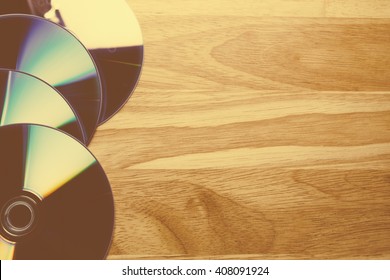 Close up view of a CD/DVD on wood table, vintage tone
