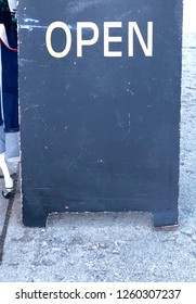 Close Up View Of Chalkboard Sidewalk Sign With The Word Open. Area Below To Add Text