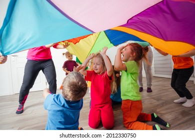 Close Up View Of Children Under Huge Rainbow Cover