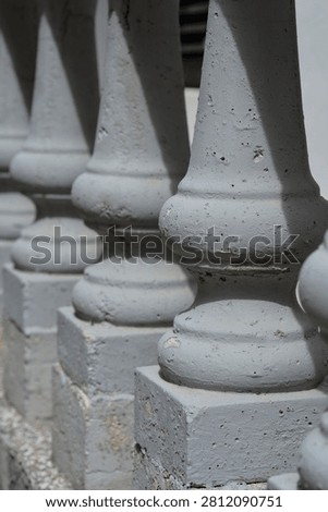 Close up view of classic concrete balusters in a row creating a decorative railing architecture background