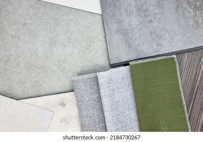 close up view of combination of interior material samples consists curtain fabric swatch, cement lamnated, concrete and marble vinyl floorings, italian walnut veneer, interior fabric wallpaper.